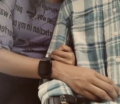 two people with their arms around each other, one holding the other's arm