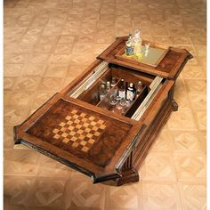 a wooden table with chess board and liquor bottles in it on top of the floor