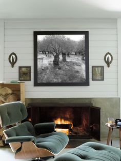 a living room filled with furniture and a fire place in front of a painting on the wall