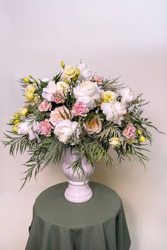 A luxurious urn design full of soft colors and blousy blooms has a no form or floral netting construction. It's filled with White Cloud and Princess Maya roses, antique carnations, yellow lisianthus, Oregonia, and grevillea. Urn Design, Go Big Or Go Home, Design Institute, Floral Style, Love Flowers, Exquisite Design, Soft Colors