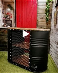 a large metal container sitting on top of a green floor next to a red door