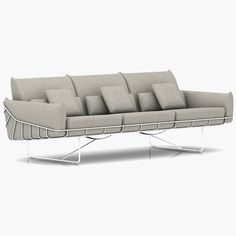 a couch that is sitting on some metal legs