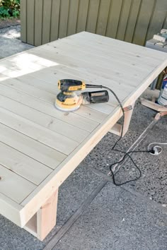 an electric sander is sitting on top of a table that has been made out of pallets