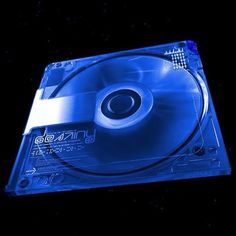 a blue cd case sitting on top of a black surface with space in the background