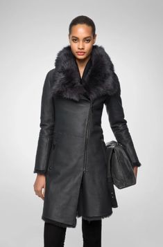 Women's Fur Shearling Leather Coat In Matte Black Experience the luxury of our women's fur shearling leather coat in matte black. Crafted from genuine sheepskin leather with a semi-aniline finish, this coat features a warm faux shearling inner shell. The design includes a zipper closure, a plush fur collar, and open hem cuffs for a sophisticated look. Practicality meets elegance with one inside pocket and two side zip pockets. This matte black coat offers a perfect blend of style and comfort for Leather Shorts Women, Leather Jumpsuit, Shearling Vest, Leather Industry, Studded Jacket, Distressed Jacket, Suede Coat, Leather Shirt, Shearling Coat