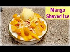 mango shaved ice cream in a bowl on a counter top with the words mango shaved ice