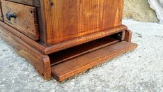 an old wooden dresser sitting on the ground