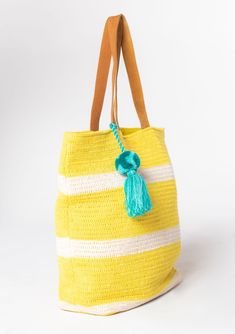 Sunny stripes add a fresh touch to this essential beach bag! Designed in bohemian crochet knit, featuring an oversize tassel accent and suede leather handles. The large carry-all size holds all your essentials with ease. Crochet knit Striped Suede leather double strap handles Oversize tassel accent Cotton Bohemian tote bag Dimensions: 21" X 18"Style: DR-8337-4 Cheap Yellow Shoulder Bag For Beach, Yellow Tote Bag, Bohemian Crochet, Boho Tote Bag, Boho Tote, Beach Tote Bag, Handcrafted Bags, Summer Bag, Beach Tote Bags