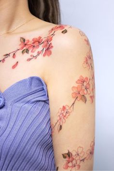 a woman's arm with flowers on it