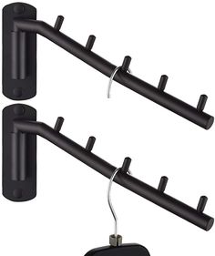 two black wall mounted tv antennas next to each other