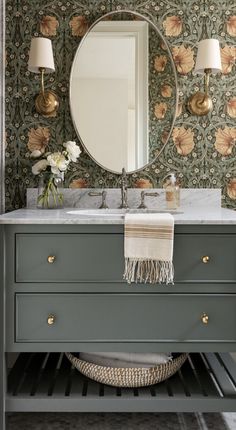 an image of a bathroom vanity with flowers on the wall and a mirror above it