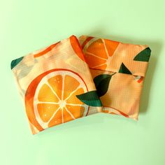 two napkins with orange slices on them