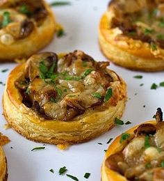 small pastries with mushrooms and parsley on a white plate