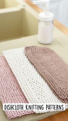 three knitted dishcloths sitting on top of a counter