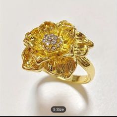 Beautiful 18k Gold Plated Flower Ring With Tiny Cz's In The Center. The Ring Is Very Shiny And Brilliant. Perfect As A Gift Or For Yourself. Nwt Gold Flower Ring With Brilliant Cut For Promise, Elegant Yellow Gold Cubic Zirconia Flower Ring, Flower Ring With Diamond Accents For Anniversary, Gold Diamond Flower Ring With Brilliant Cut, Gold Ring With Flower Charm Jewelry, Cubic Zirconia Yellow Gold Flower Ring, Flower Shaped Ring With Diamond Accents In Cubic Zirconia, Luxury Cubic Zirconia Flower Ring, Flower Shaped Cubic Zirconia Ring With Diamond Accents