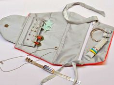 an assortment of items are laid out on a white surface, including a purse and keychain