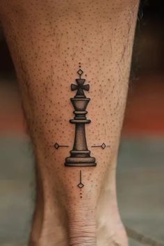 a person with a tattoo on their foot that has a chess piece drawn on it