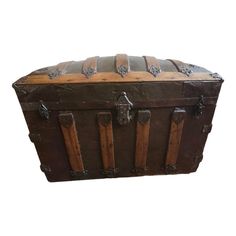 an old wooden trunk with metal handles and latches on the top is shown against a white background