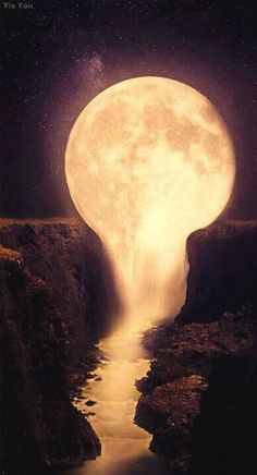 a full moon rising over a river in the middle of a mountain range with water running through it