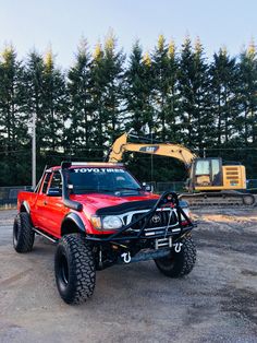 a red truck parked in front of a construction site