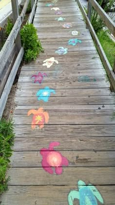 a wooden walkway with flowers painted on it