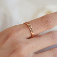 a close up of a person's hand with a gold ring on their finger