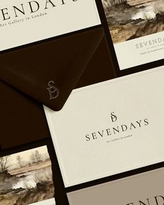 several business cards and envelopes with the words seven days written in black on them