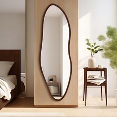 a bedroom with a large mirror on the wall next to a chair and table in front of it