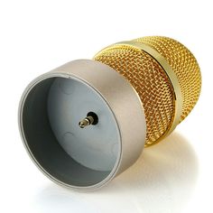 two golden microphones sitting next to each other on a white surface