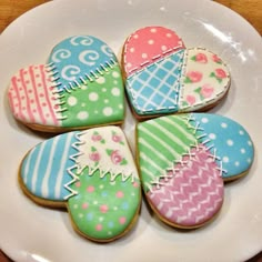 decorated cookies are arranged on a white plate