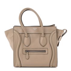 This is an authentic CELINE Drummed Calfskin Micro Luggage in Dune. This bag is crafted of luxurious pebbled calfskin leather in beige. It features rolled leather top handles, expandable sides, a frontal zipper pocket, and decorative leather trim. The top zipper opens to a fabric interior with zipper and patch pockets. Leather Top, Leather Trim, Leather Trims, Patch Pocket, Drums, Zipper Pocket, Top Handle, Calf Skin, Handles