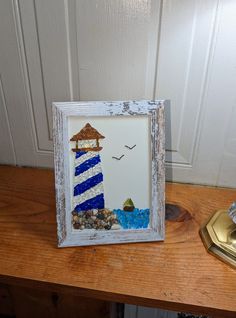 a picture frame sitting on top of a wooden table