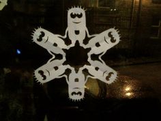 the snowflake is cut out to look like it has eyes