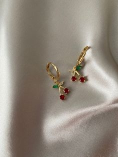 These small beautiful earrings are available plated in real 18k gold, the cherry is made of AAA cubic zirconia gems!  Sold as a pair! Matching necklace sold separately: https://www.etsy.com/uk/listing/916466685/silver-gold-cherry-necklace-gold-filled?ref=shop_home_active_10&frs=1&sca=1  DETAILS * high quality rhodium with 18k gold plating  * non tarnish and waterproof  * classic and super trendy  * 18k gold plating * Cubic zirconia cherry  * Length: 25 mm  We also have these huggies in silver! https://www.etsy.com/uk/listing/916603705/silver-cherry-earrings-white-gold-plated? ref=shop_home_active_2&frs=1  PACKAGING Each piece is beautiful wrapped up in tissue paper, sealed with a branded sticker, then gifted in a complimentary cute pouch, perfect for safekeeping and gifting.  DELIVERY UK o Dainty Plated Earrings For Gifts, Dainty Plated Earrings As Gift, Trendy 14k Gold Filled Huggie Earrings As Gift, Trendy 14k Gold Filled Huggie Earrings For Gift, Trendy Cubic Zirconia Huggie Earrings As Gift, Elegant Cherry Drop Earrings, Gift Gold Plated Huggie Earrings, Cute Huggie Jewelry Gift, Cute Huggie Jewelry As A Gift