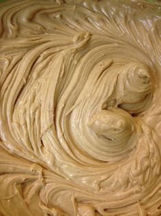 a bowl filled with cream sitting on top of a table