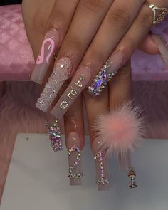 a manicure with pink and silver glitters on the tip of it, and a flamingo in the middle