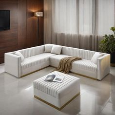 a living room with a white couch and ottoman