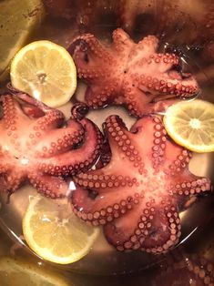 an octopus and lemons are being cooked in water