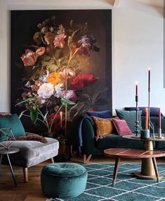 a living room filled with furniture and a painting on the wall