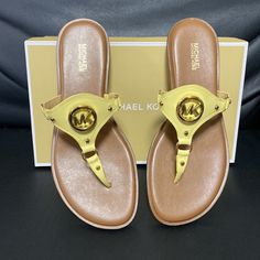 Brand New Michael Michael Kors, The Conway Leather Sandals Feature: Leather Upper Slip-On Styling Padded Insole Synthetic Lining Rubber Outsole Size: 8 Or 9 Color: Buttercup Gold Sandals With Leather Footbed And Flat Heel, Gold Leather Heels For Vacation, Gold Round Toe Sandals With Leather Footbed, Gold Leather Flat Flip Flops, Gold Sandals With Leather Footbed, Round Toe, Leather Footbed Flat Flip Flops, Gold Flat Sandals With Cushioned Footbed, Gold Synthetic Sandals With Single Toe Strap, Gold Sandals With Single Toe Strap