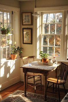 the sun shines through two windows into a dining room with wooden chairs and table