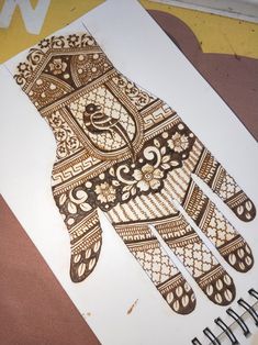 an intricately designed hand is shown on a piece of paper