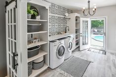 a washer and dryer in a laundry room next to a door that leads to a pool