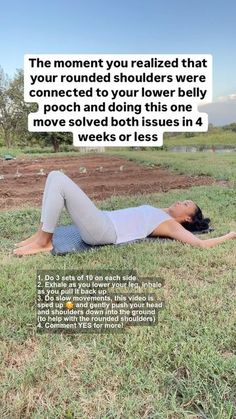 a woman laying on the ground in a field