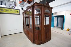 an old wooden phone booth in the middle of a building