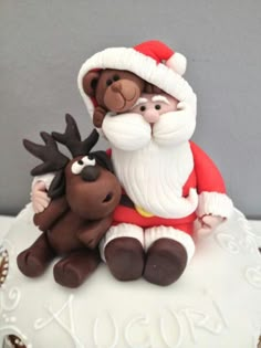 there is a christmas cake with santa and reindeer on it