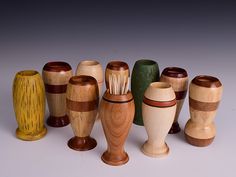 a group of wooden vases sitting next to each other