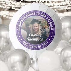 a graduation party decoration with balloons and confetti in the shape of an ornament