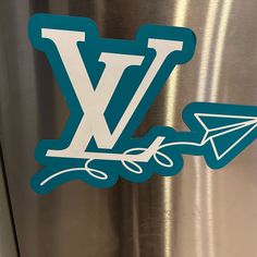 a sticker on the side of a refrigerator that says w is for paper airplane