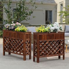 two wooden planters sitting next to each other on top of a cement floor covered patio